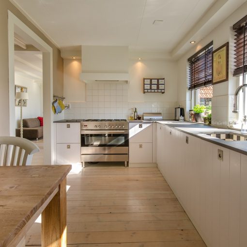 Spacious kitchen showcasing modern home extensions with wooden countertops and natural lighting.